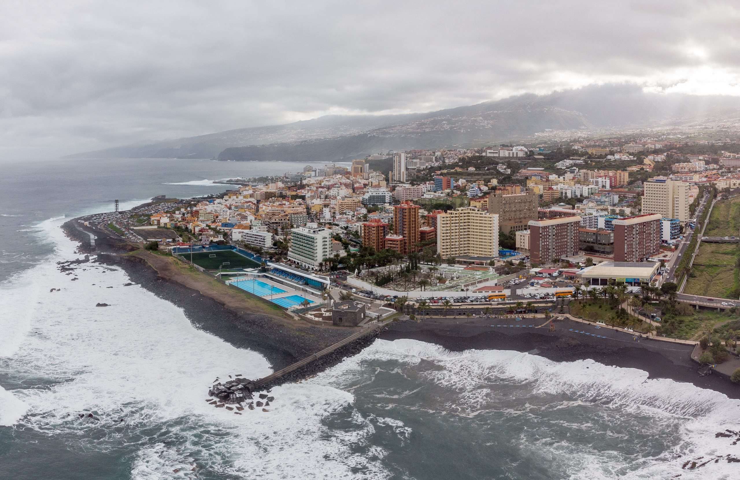 Puerto de la Cruz seen from the Playa Jardín area, with the coastline, town and slopes of the valley